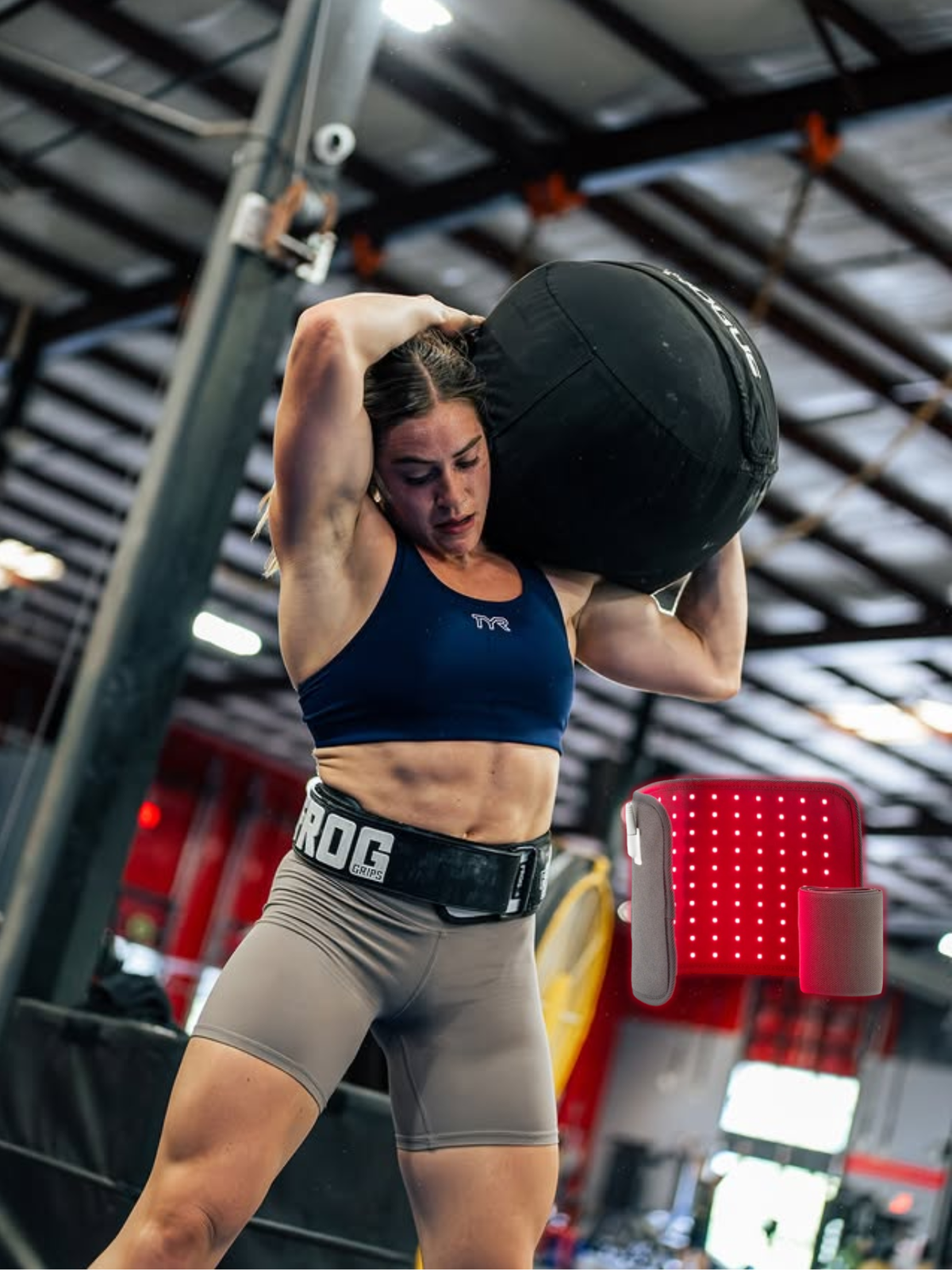 CrossFit athlete holding their shoulder after an overhead lifting session, box in background